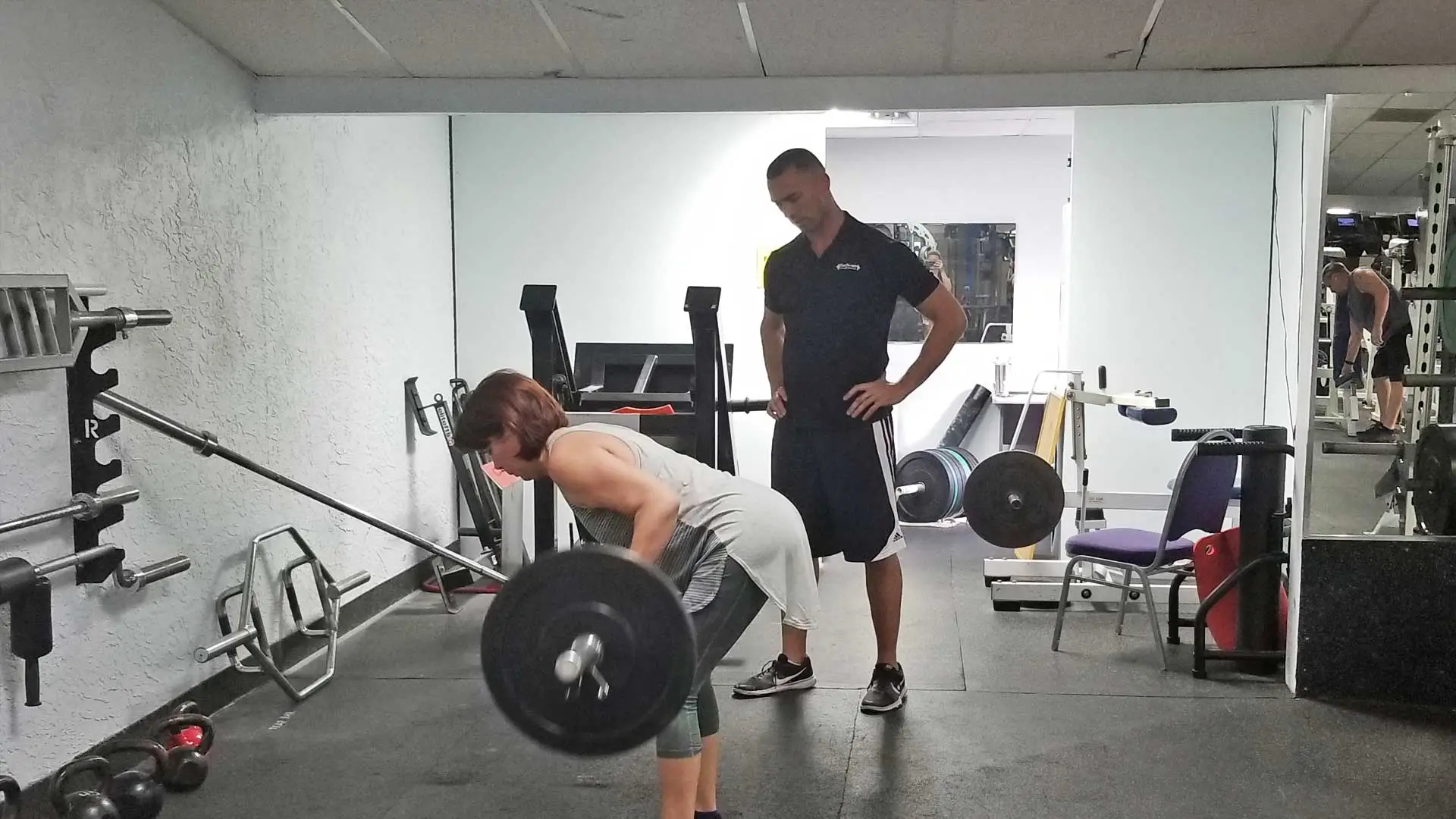 Personal training instruction on how to do a barbell row in Apollo Beach.