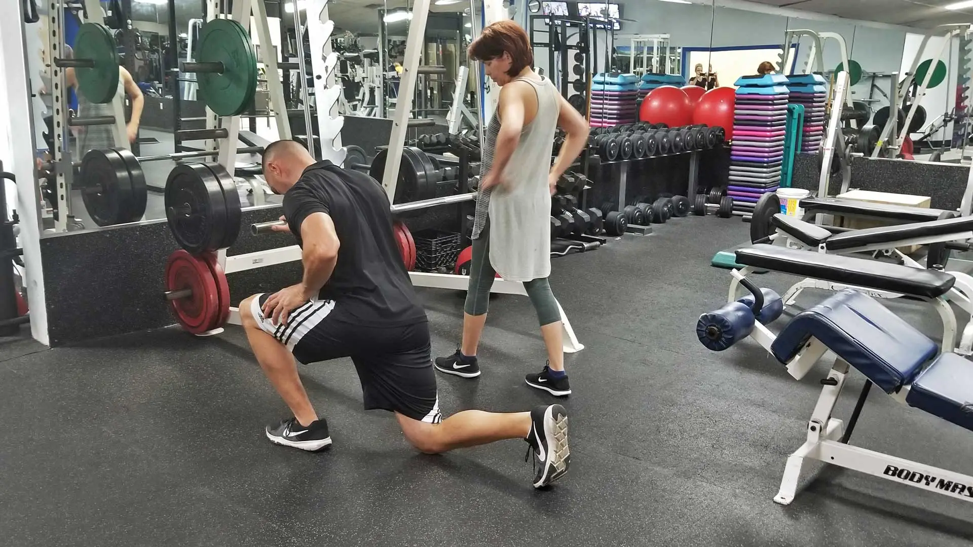 Personal trainer, Francois Tort teaching a client the proper way to do a reverse lunge in Ruskin, FL.