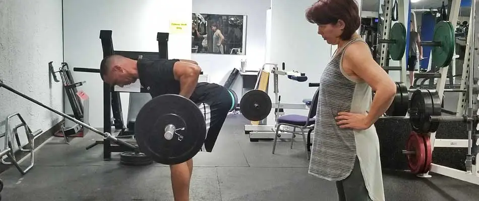 Personal training instruction on how to row at a gym in Apollo Beach, FL.